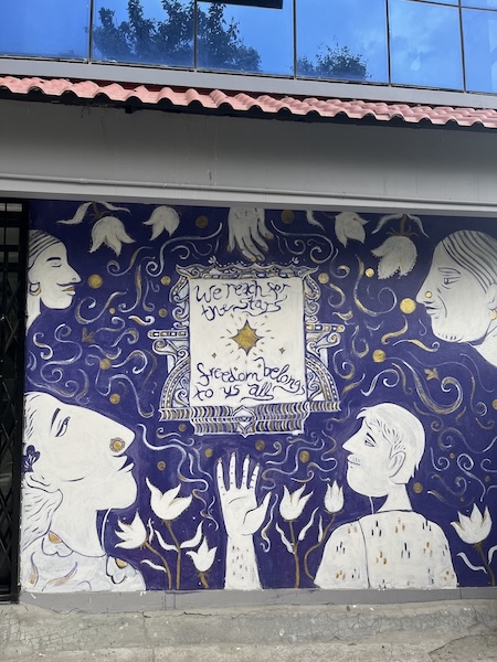 Mural that says we reach for the stars, freedom belongs to us all