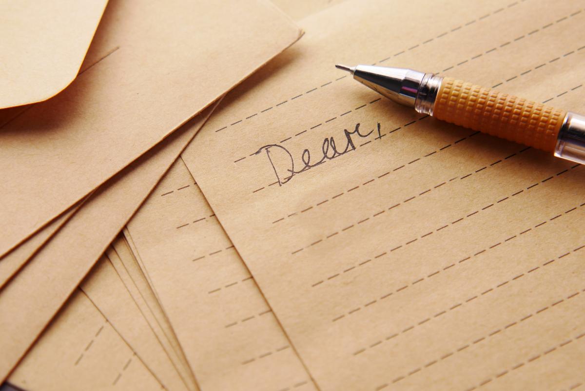 Paper with Dear, written on it with pen