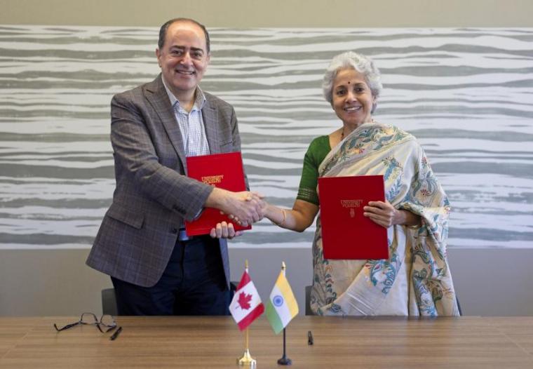 Prof. Shayan Sharif (left) and Dr. Soumya Swaminathan (right) shaking hands